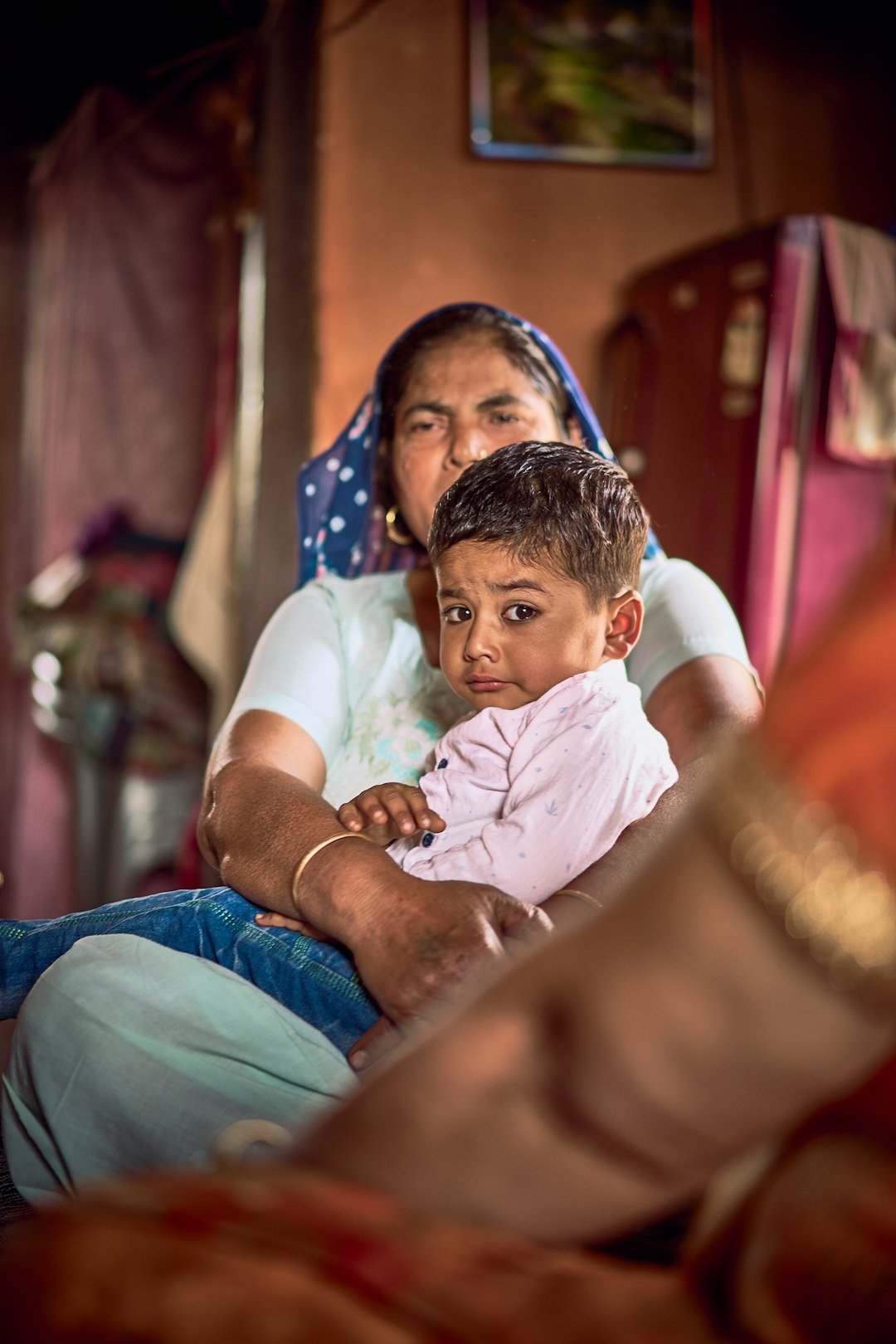 Female baby care taker holding child at home