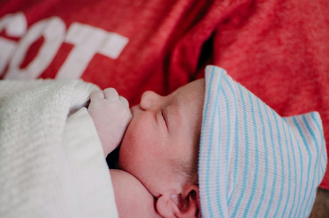 Newborn baby sleeping peacefully under 24 hour care